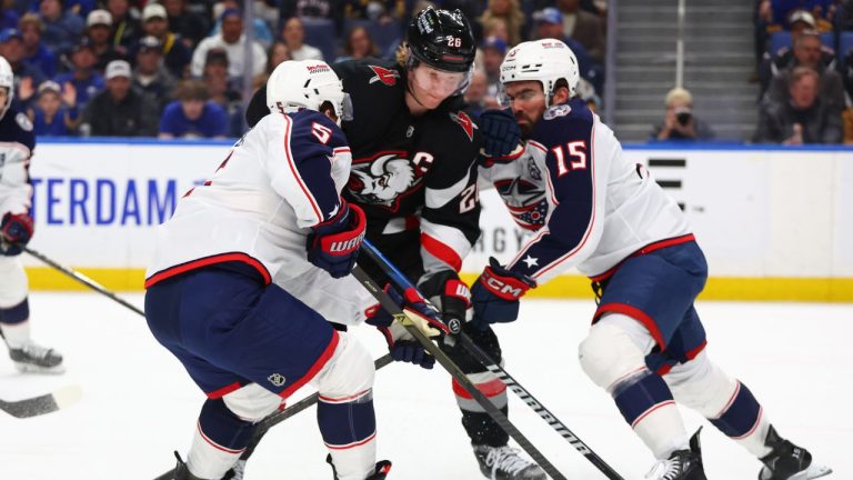 Buffalo Sabres defenseman Rasmus Dahlin (26) skates between Columbus Blue Jackets defenseman Denton Mateychuk (5) and Dante Fabbro (15) during the first period of an NHL hockey game Thursday, April 9, 2026, in Buffalo, N.Y. (Jeffrey T. Barnes/AP)